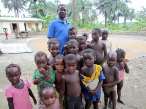 Chief Caulker with village children at his rice farm.