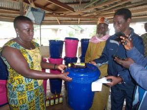 Chief Caulker & CCET Exec Dir, Rosaline Kaimbay show buckets ready to distribute for hand washing