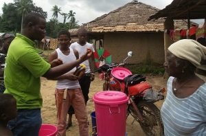 Alpha distributes buckets & hand washing message